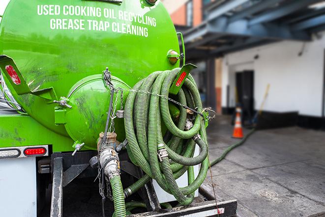 a grease trap being pumped by a sanitation technician in Shiloh